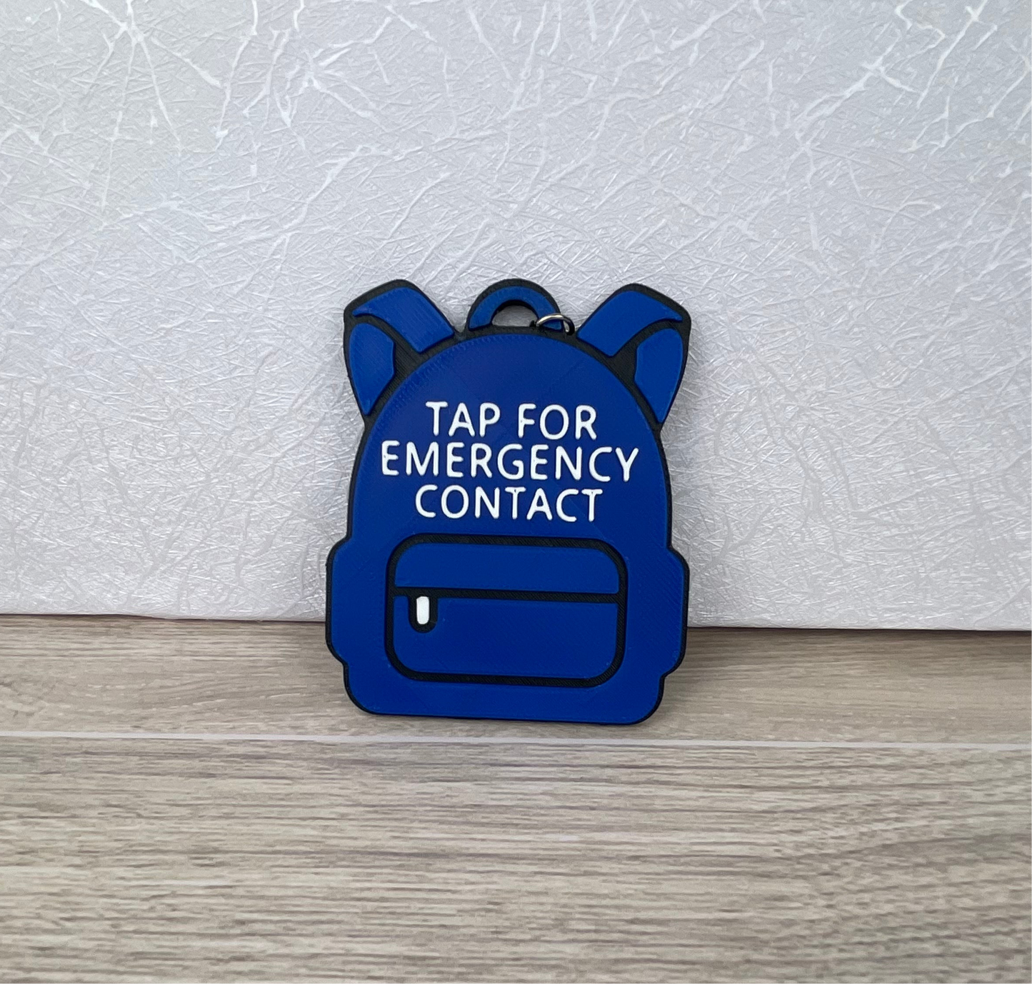 customizable 3D printed backpack NFC emergency tag! Designed in the shape of a cute backpack, this tag allows anyone to simply tap their phone to the tag to access a pre-programmed emergency contact.