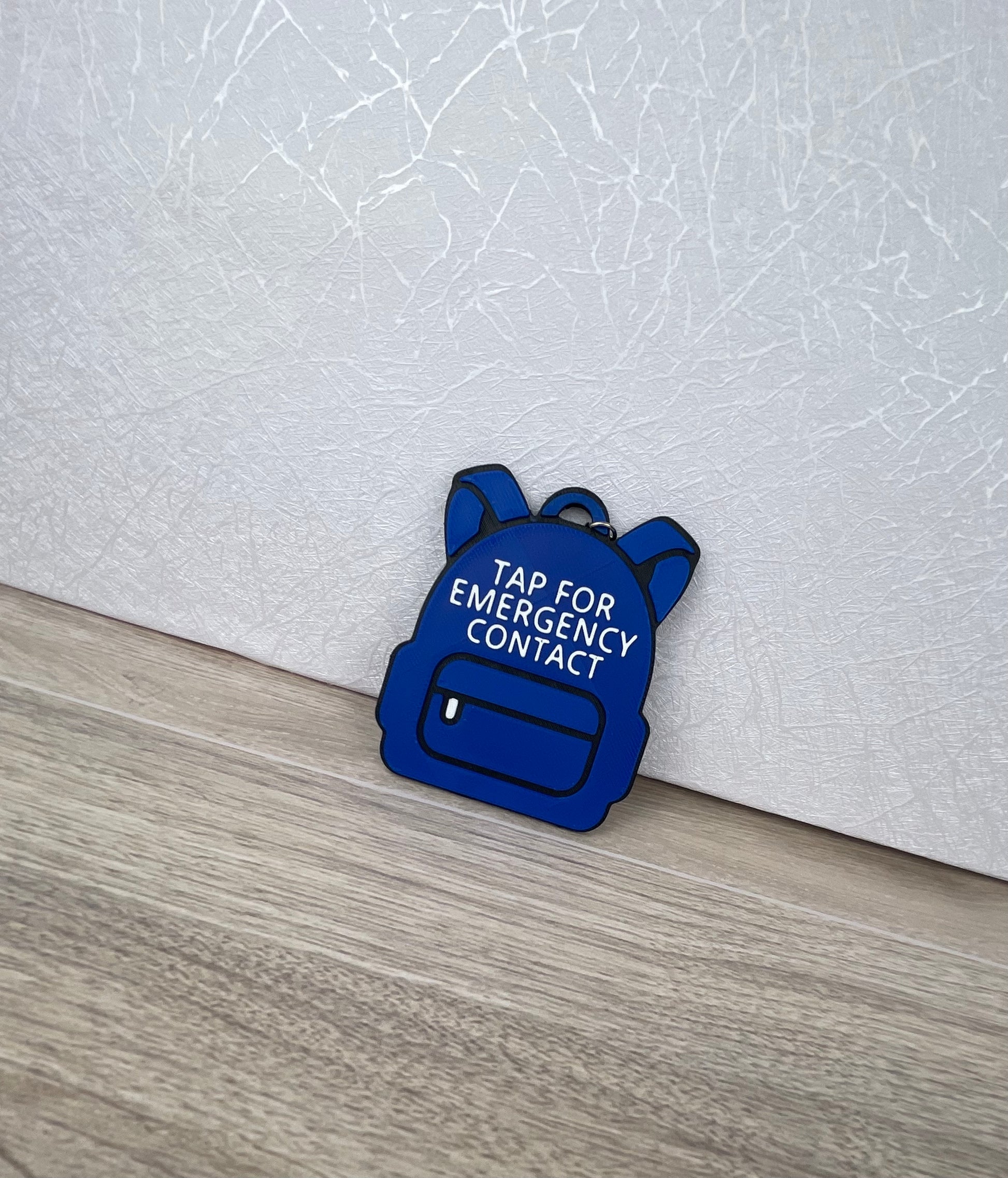 customizable 3D printed backpack NFC emergency tag! Designed in the shape of a cute backpack, this tag allows anyone to simply tap their phone to the tag to access a pre-programmed emergency contact.