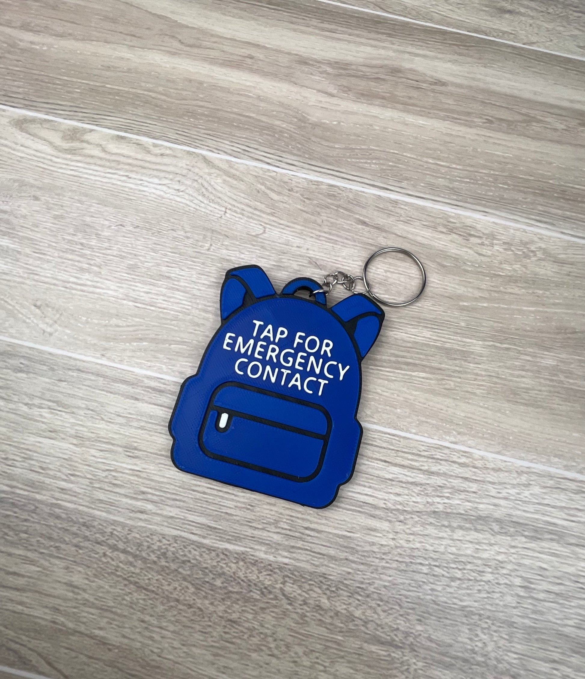customizable 3D printed backpack NFC emergency tag! Designed in the shape of a cute backpack, this tag allows anyone to simply tap their phone to the tag to access a pre-programmed emergency contact.